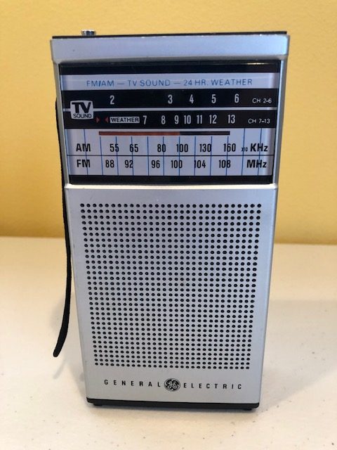 General Electric Model 7-2934A AM-FM-TV-WEATHER Bands Portable Transistor Radio, 1960s, silver front with black case, telescoping antenna, works good. Value: $50. Minimum Bid: $35.