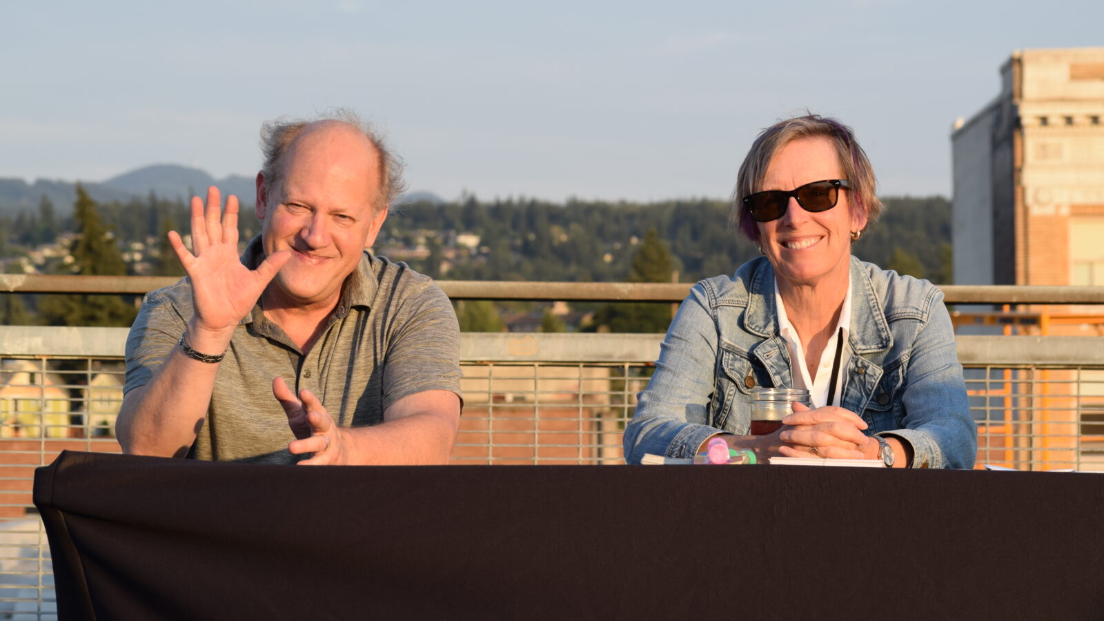 Two KMRE volunteers sitting at a table
